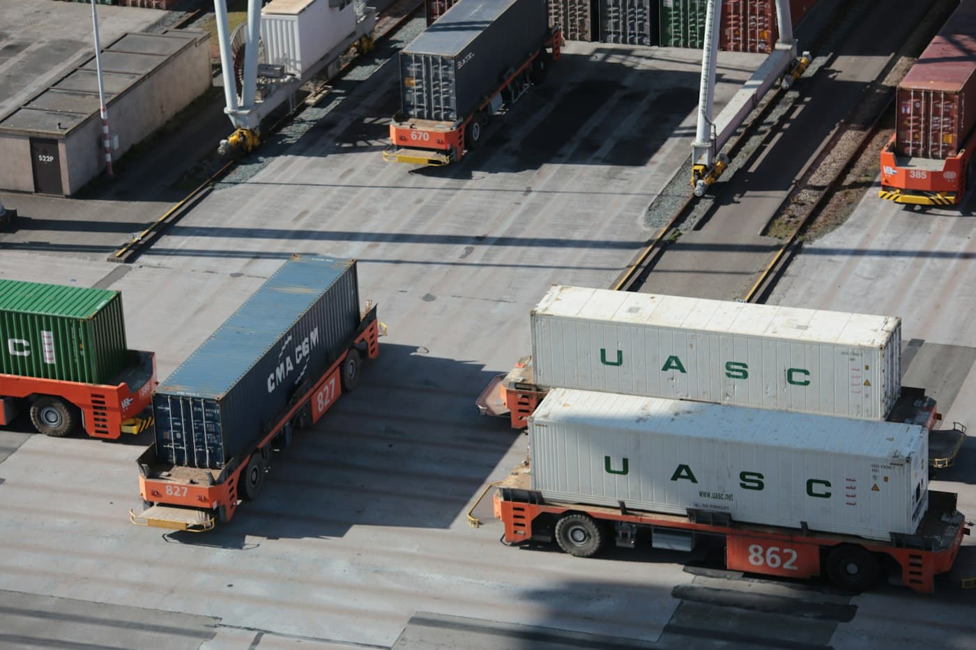 Container trucks moving through a port yard