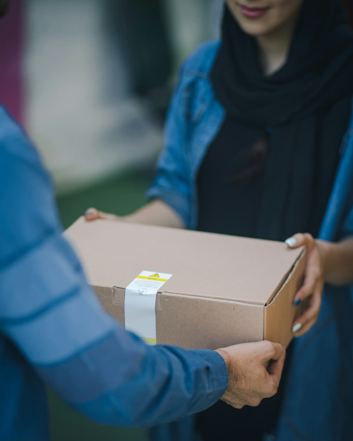 A parcel being handed over at delivery